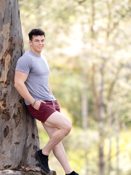 Hunky gay bodybuilder Clark Reid flashes his ass outdoors before posing naked